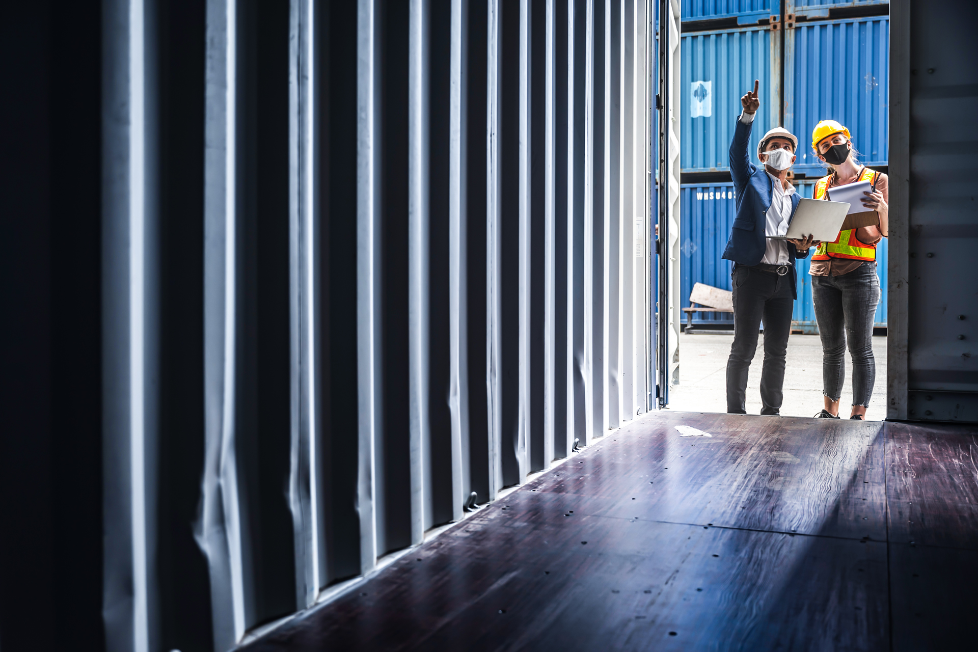 people inspect shipping container