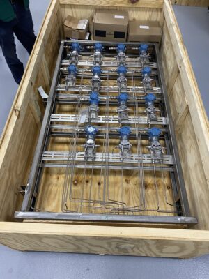 Transmitter stand securely packed in a wooden crate for international shipment.
